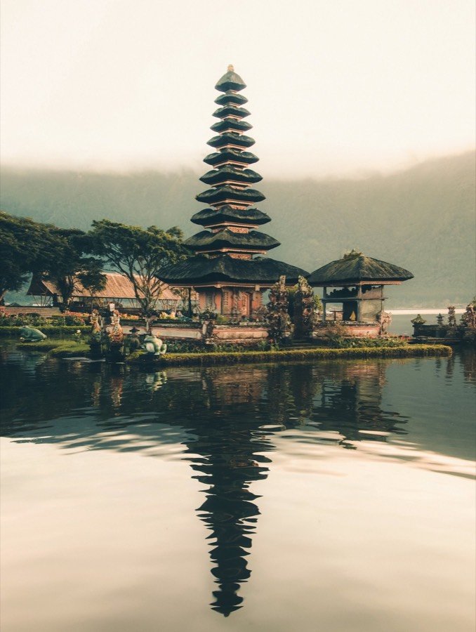Water temple reflected on a misty lake in Bali
